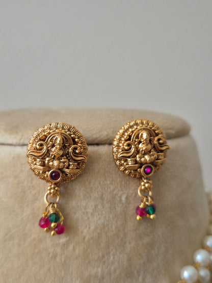 Gold earrings with intricate designs and colorful beads by naitri.in