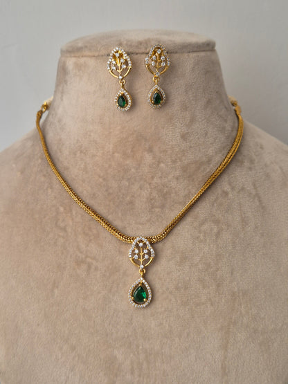 Gold necklace with green gemstones with earrings minimal design, style everywhere to look stunning by naitri.in