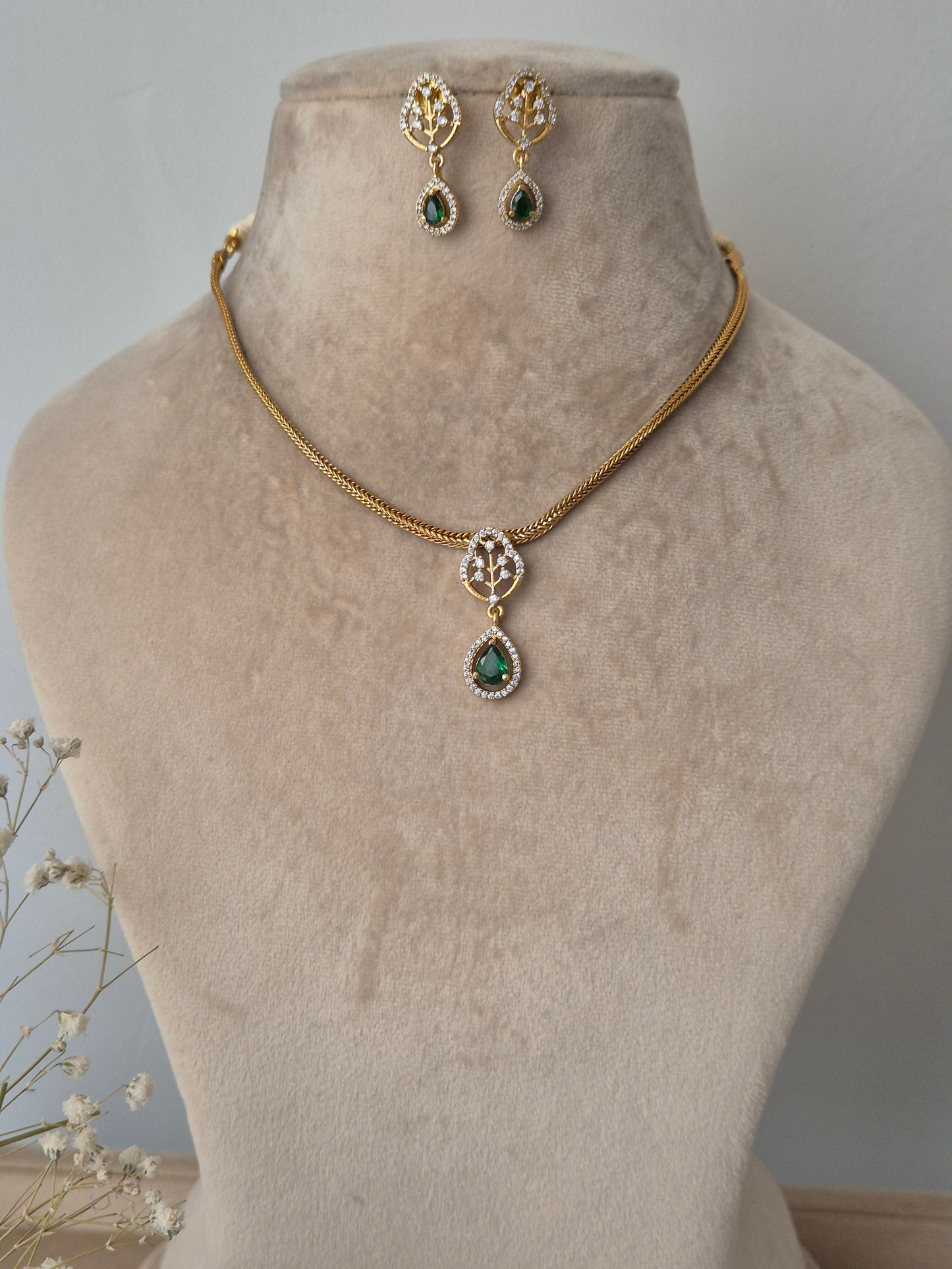 Gold necklace with green gemstones golden chain by naitri.in