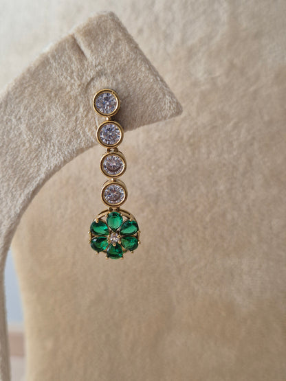 Gold-toned earrings with green gemstone flower motifs, featuring clear round stones by naitri.in
