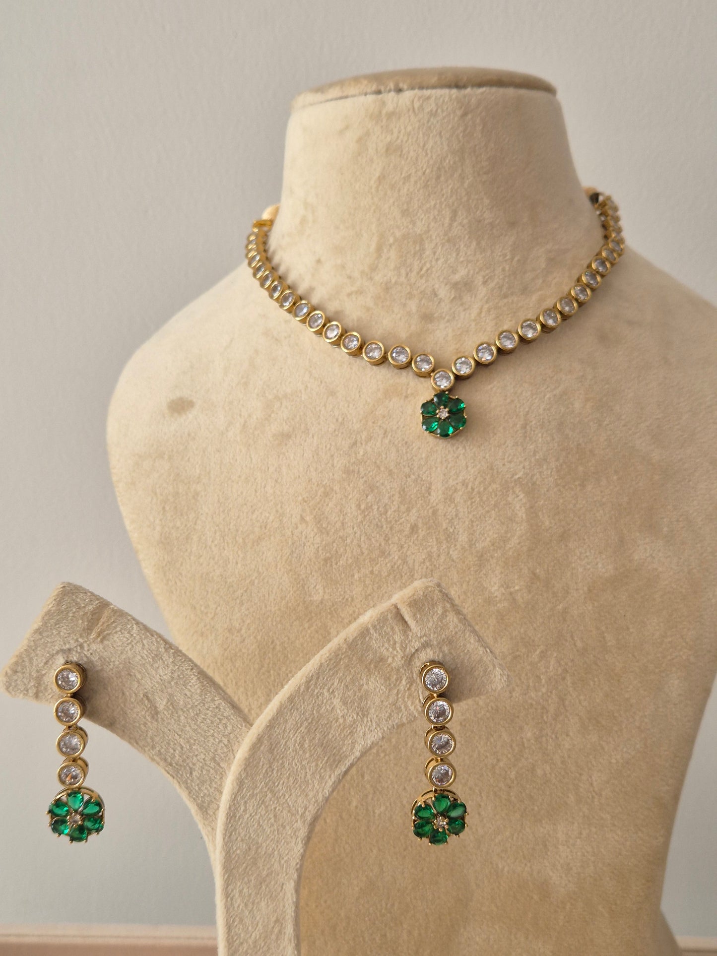 Necklace Set featuring a delicate gold-toned chain with white circular stones and a vibrant green floral pendant, including matching green flower drop earrings by naitri.in