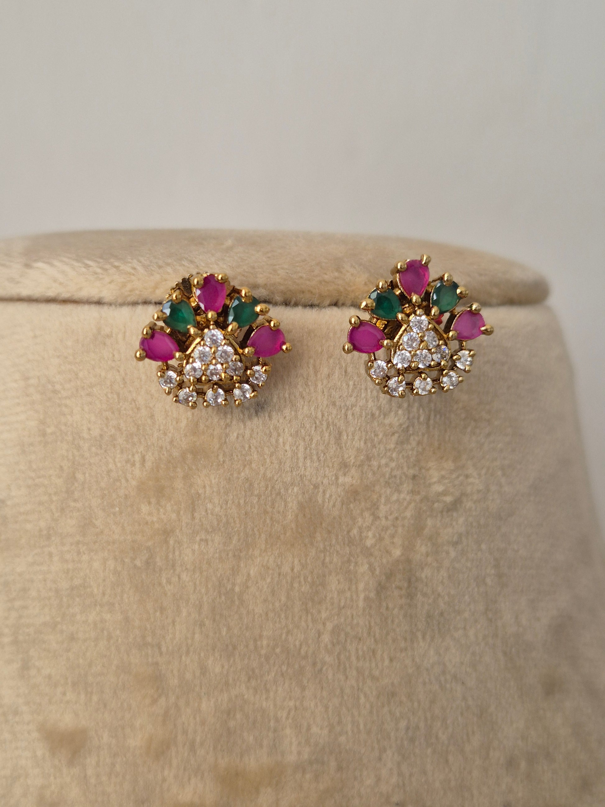 Minimal earrings featuring flower charms with pink and green stone petals by naitri.in