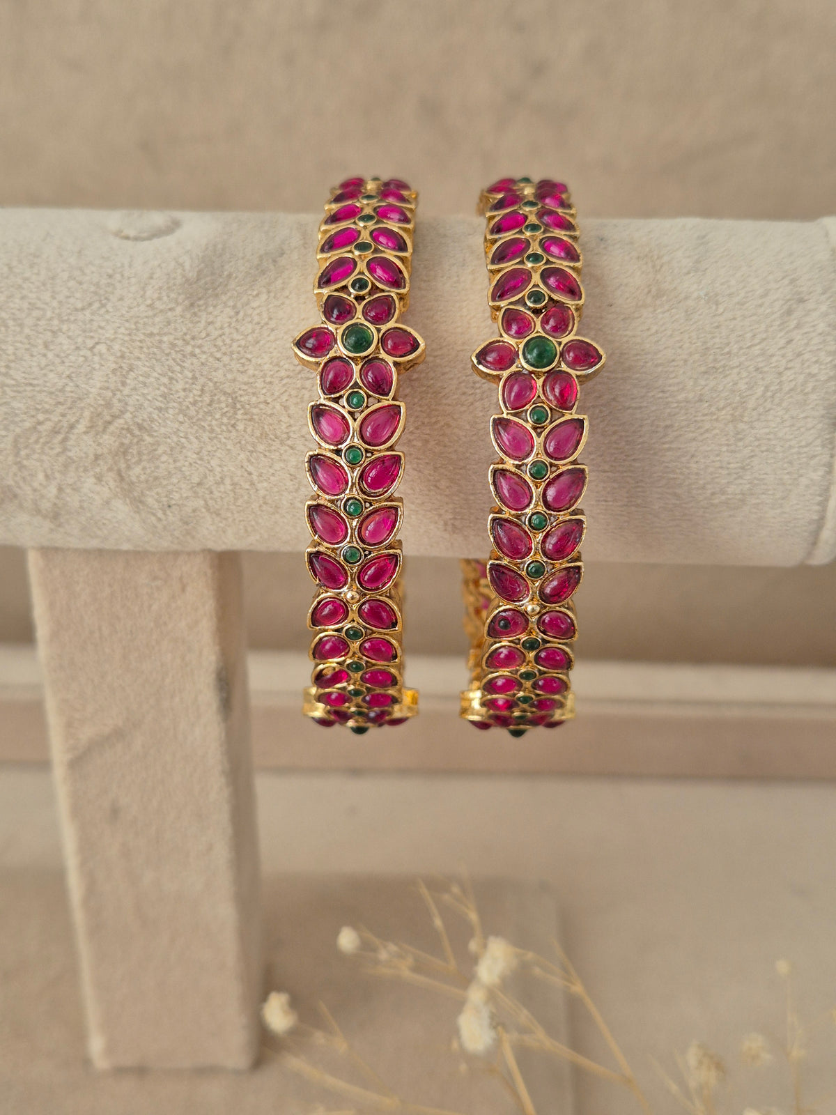 Set of two pink and green stone-studded gold-plated bangles by naitri.in