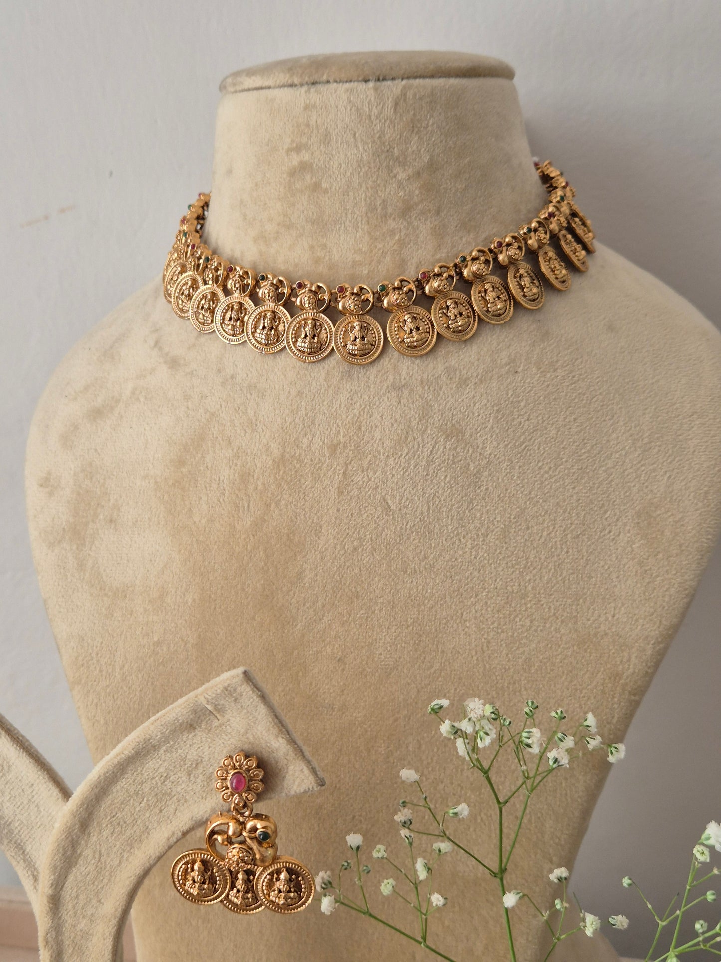 Elegant gold-toned ethnic choker jewelry set with detailed antique design work Gold-plated traditional coin choker necklace and matching by naitri.in 