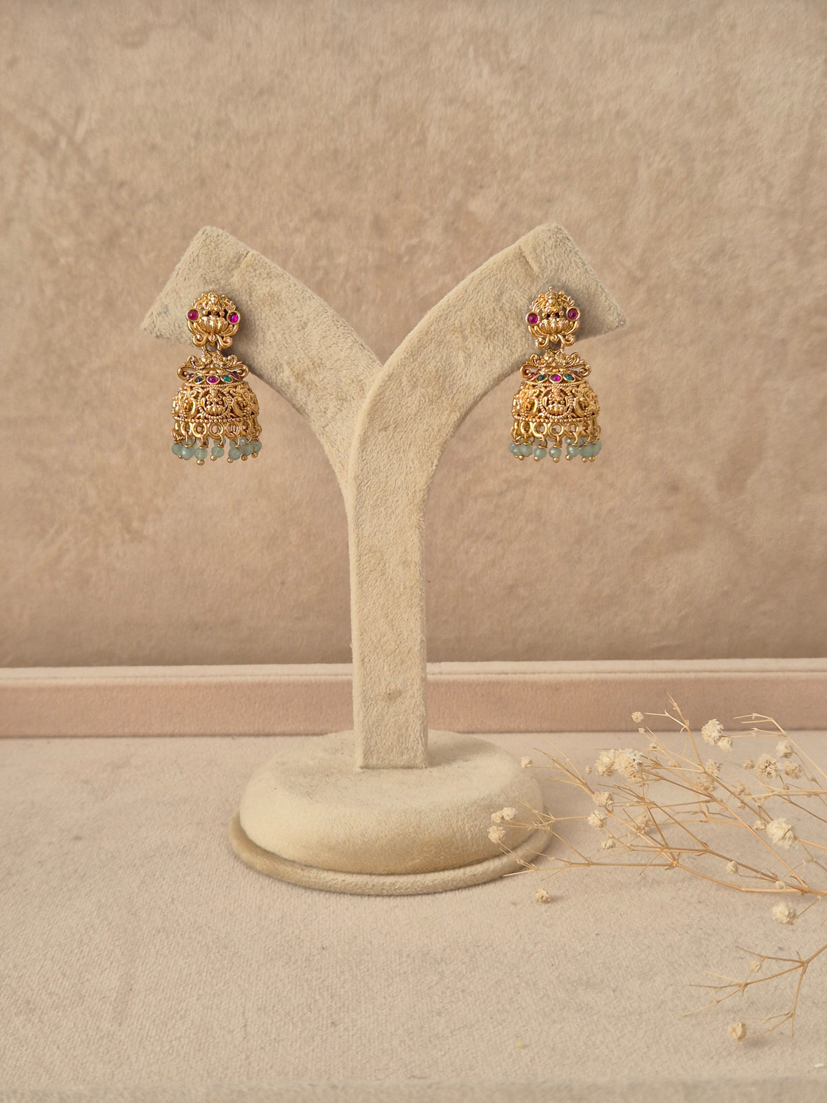 Manjari handcrafted gold-finish jhumka earrings with ruby and emerald-stone embellishmentsby naitri.in