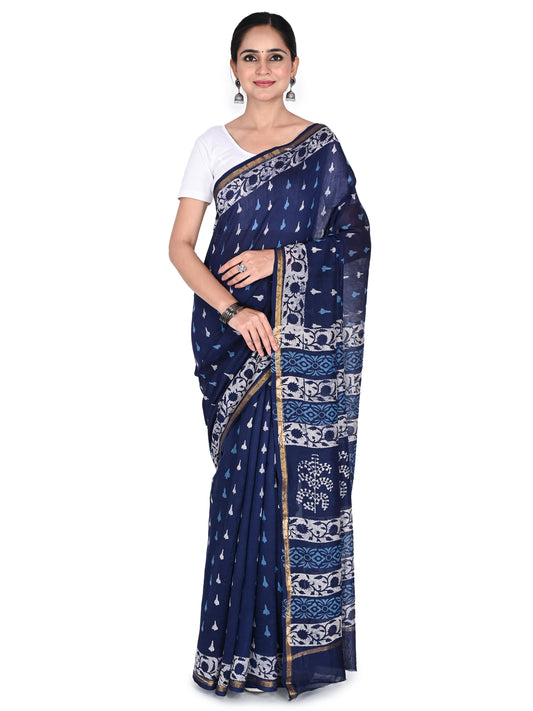 A model wearing the navy blue cotton-silk saree featuring traditional white hand-block prints, a gold zari border, and a classic drape, paired with a white short-sleeved blouse by naitri.in