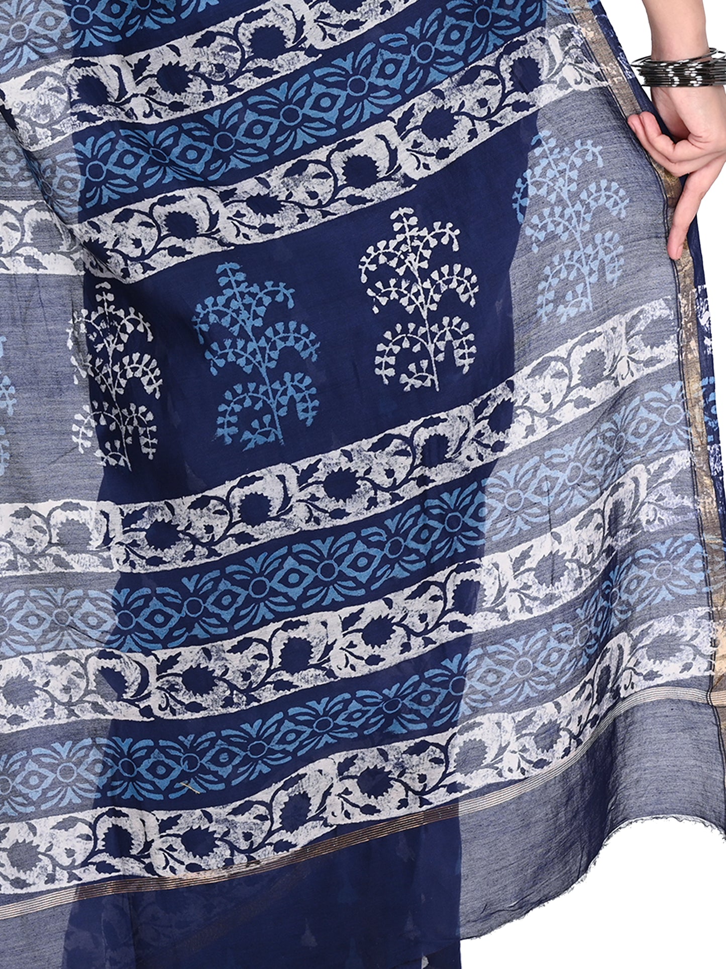 Full-length view of the Manjita saree in a deep navy blue cotton-silk blend, showcasing the intricate white artisanal block prints and shimmering gold zari border pallu by naitri.in