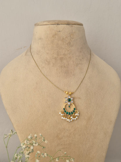 Golden crescent moon pendant necklace with clear and green stonework and small pearl hangings by naitri.in
