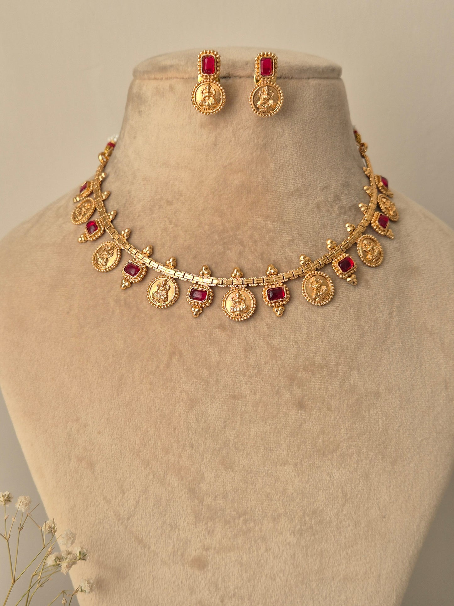 Gold necklace with red gemstones coin designed  Naitri on bust form by naitri.in