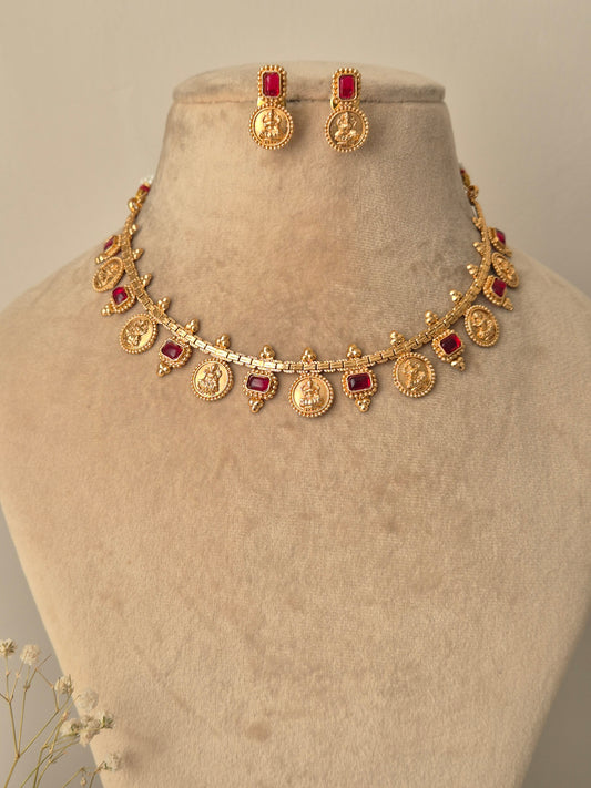 Gold necklace with red gemstones coin designed  Naitri on bust form by naitri.in