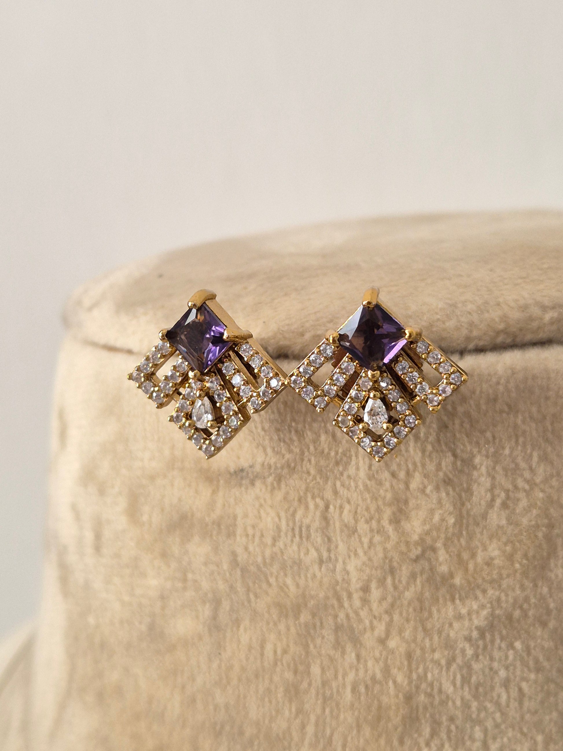 Minimalist gold-toned earrings with square-shaped charms accented with purple gemstones and clear crystals, by naitri.in 