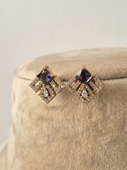 Minimalist gold-toned earrings with square-shaped charms accented with purple gemstones and clear crystals, by naitri.in 