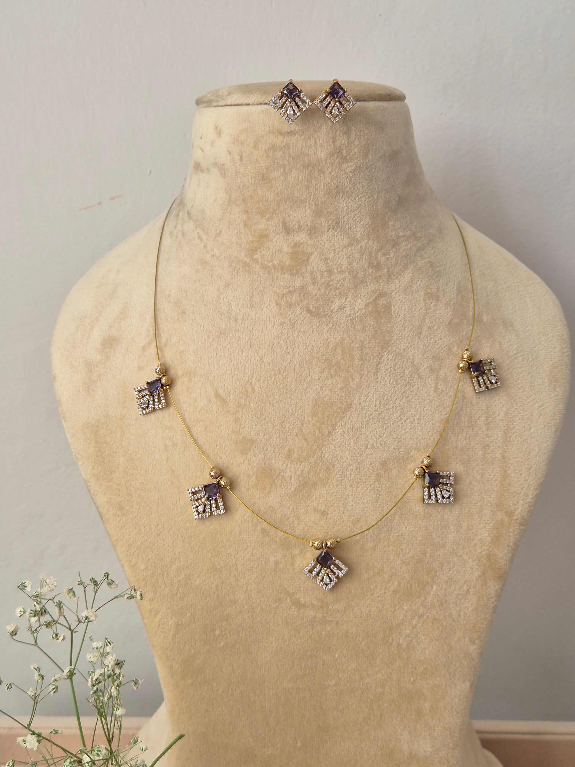 Delicate gold chain necklace with geometric diamond-shaped dangles and matching earrings by naitri..in