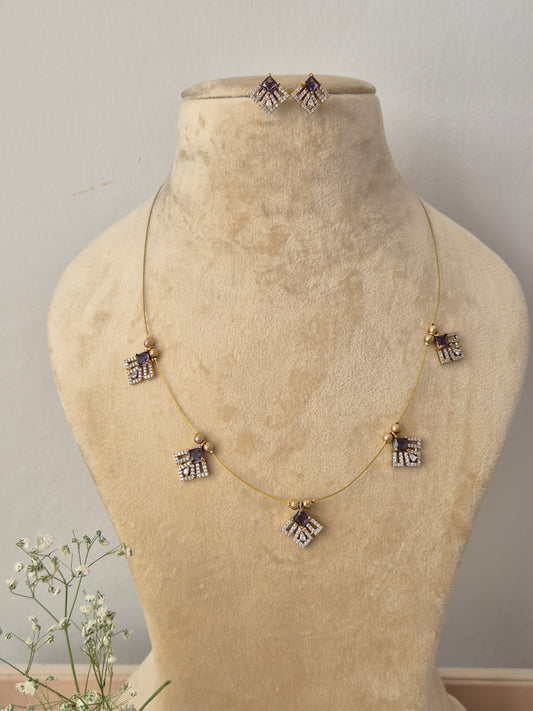 Delicate gold chain necklace with geometric diamond-shaped dangles and matching earrings by naitri..in