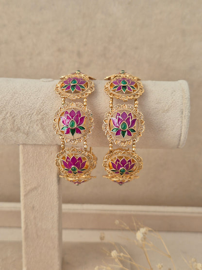 Set of 2 gold-plated bangles featuring circular lotus motifs inlaid with pink enamel petals and green stone accents, by naitri.in