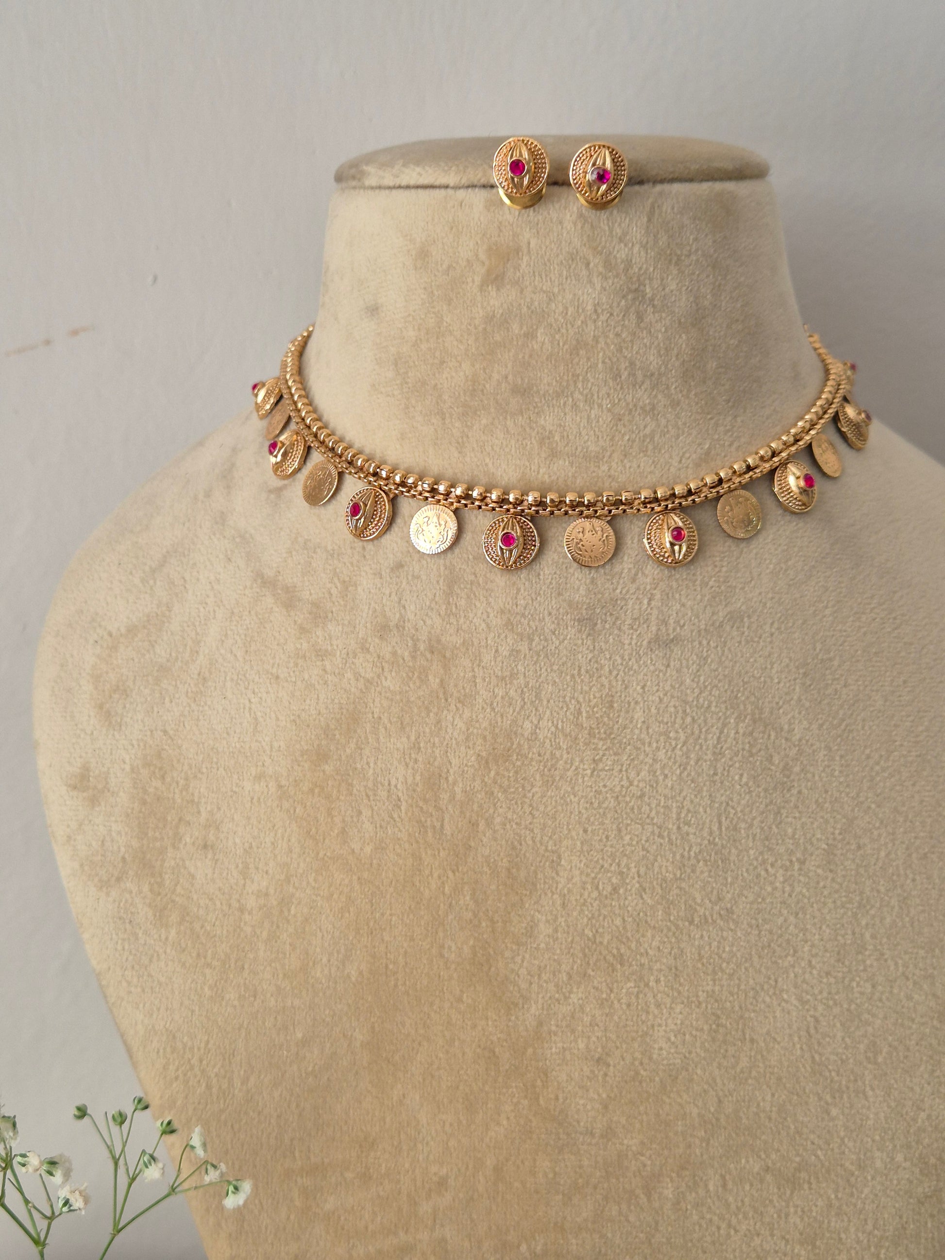 Traditional Indian style golden brass alloy choker necklace and matching stud earrings from the NAITRI ethnic jewelry collection by naitri.in
