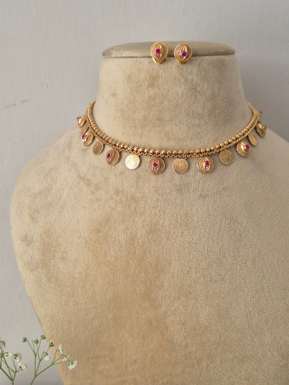 Traditional Indian style golden brass alloy choker necklace and matching stud earrings from the NAITRI ethnic jewelry collection by naitri.in