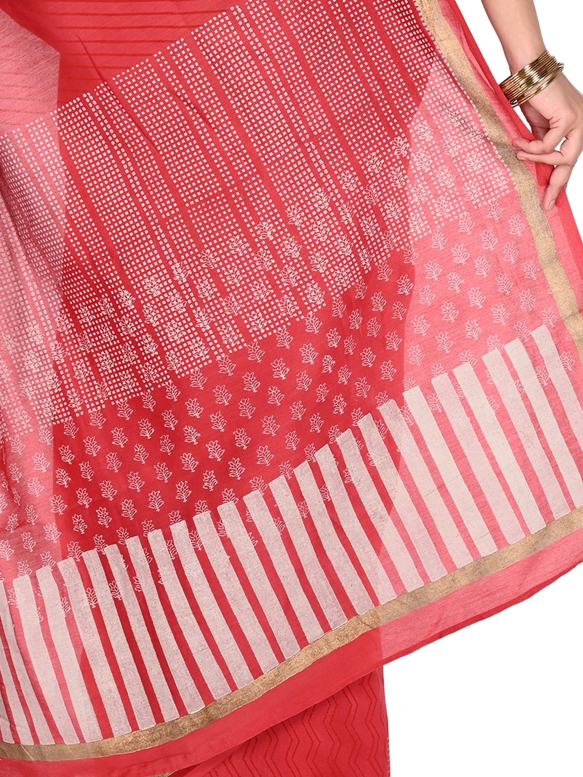 Close-up of a red cotton-silk blend saree with traditional white Bagh hand-block prints and a shimmering gold border, showcasing the fluid drape and texture pallu by naitri.in