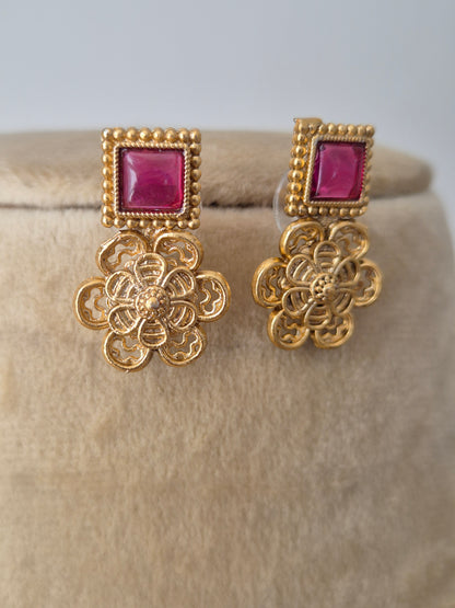 handcrafted gold-plated brass earrings studs with floral metalwork motifs, alternating square red stones by naitri.in