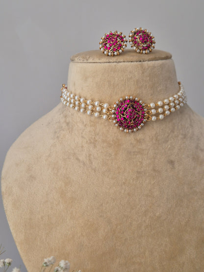 White pearl strand necklace with pink stone pendant and matching floral studs and Gold and pearl choker necklace set with pink stone embellishments by naitri.in