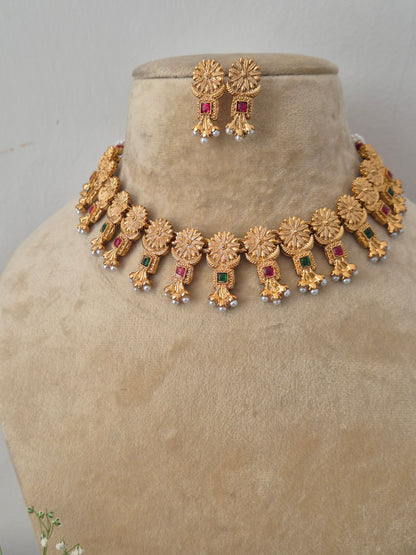 Handcrafted antique gold statement jewelry set showcasing vibrant multi-color gemstones and seed pearls, by naitri.in