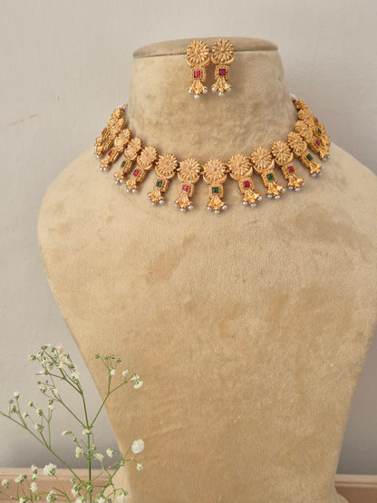 Antique gold choker necklace with dangling colorful stone pendants and matching earrings by naitri.in