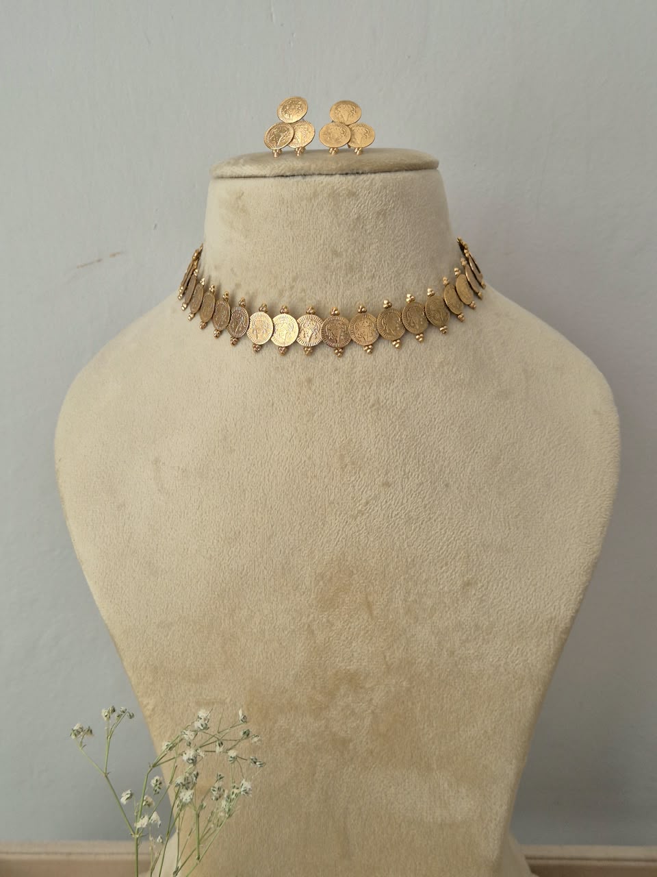 A gold coin choker necklace and matching coin earrings by naitri.in