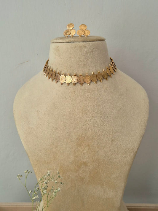 A gold coin choker necklace and matching coin earrings by naitri.in