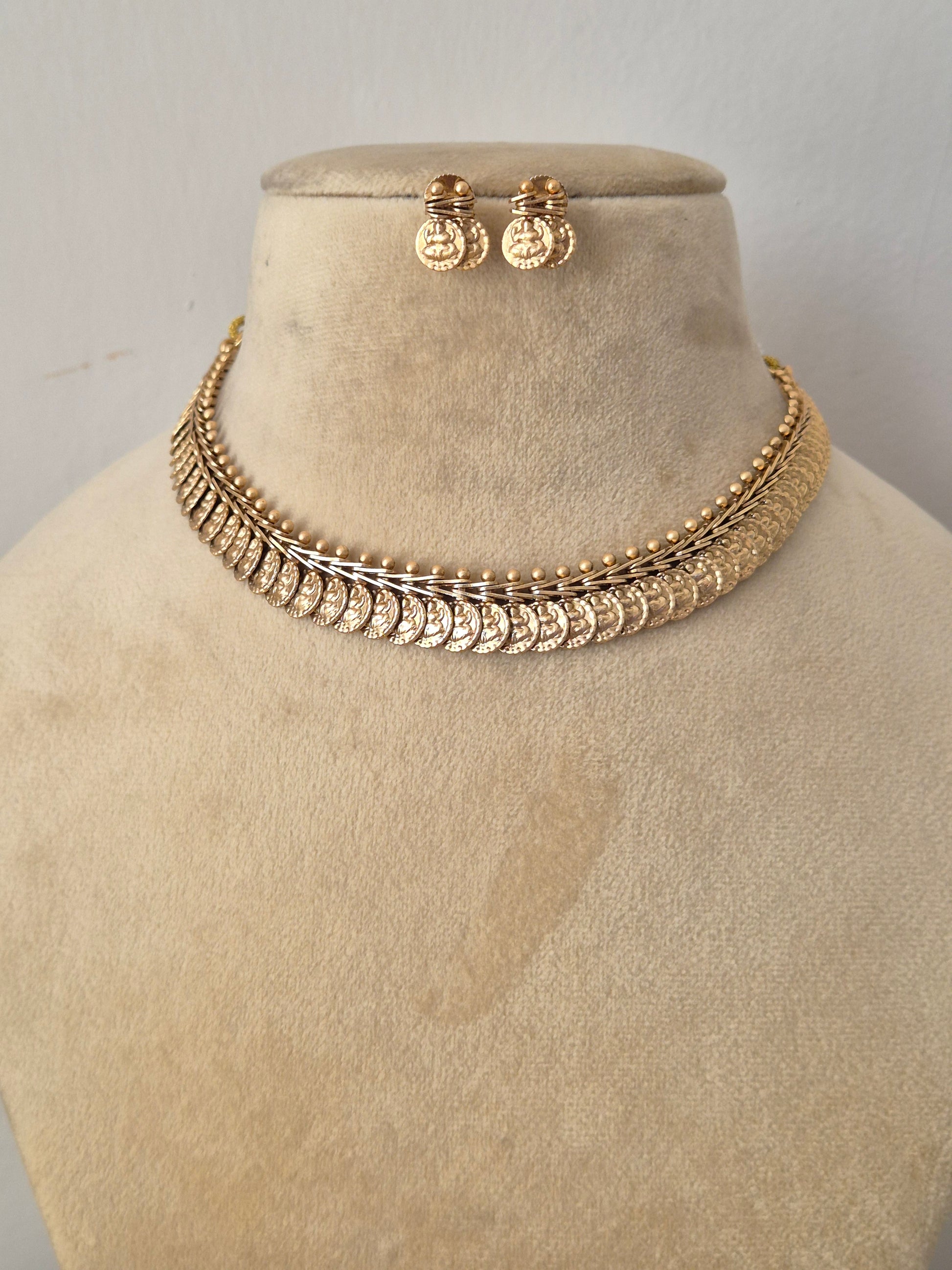 Handcrafted antique gold statement jewelry set showcasing intricate metallic coin motifs, ideal for festive, traditional, or bridal wear by naitri.in