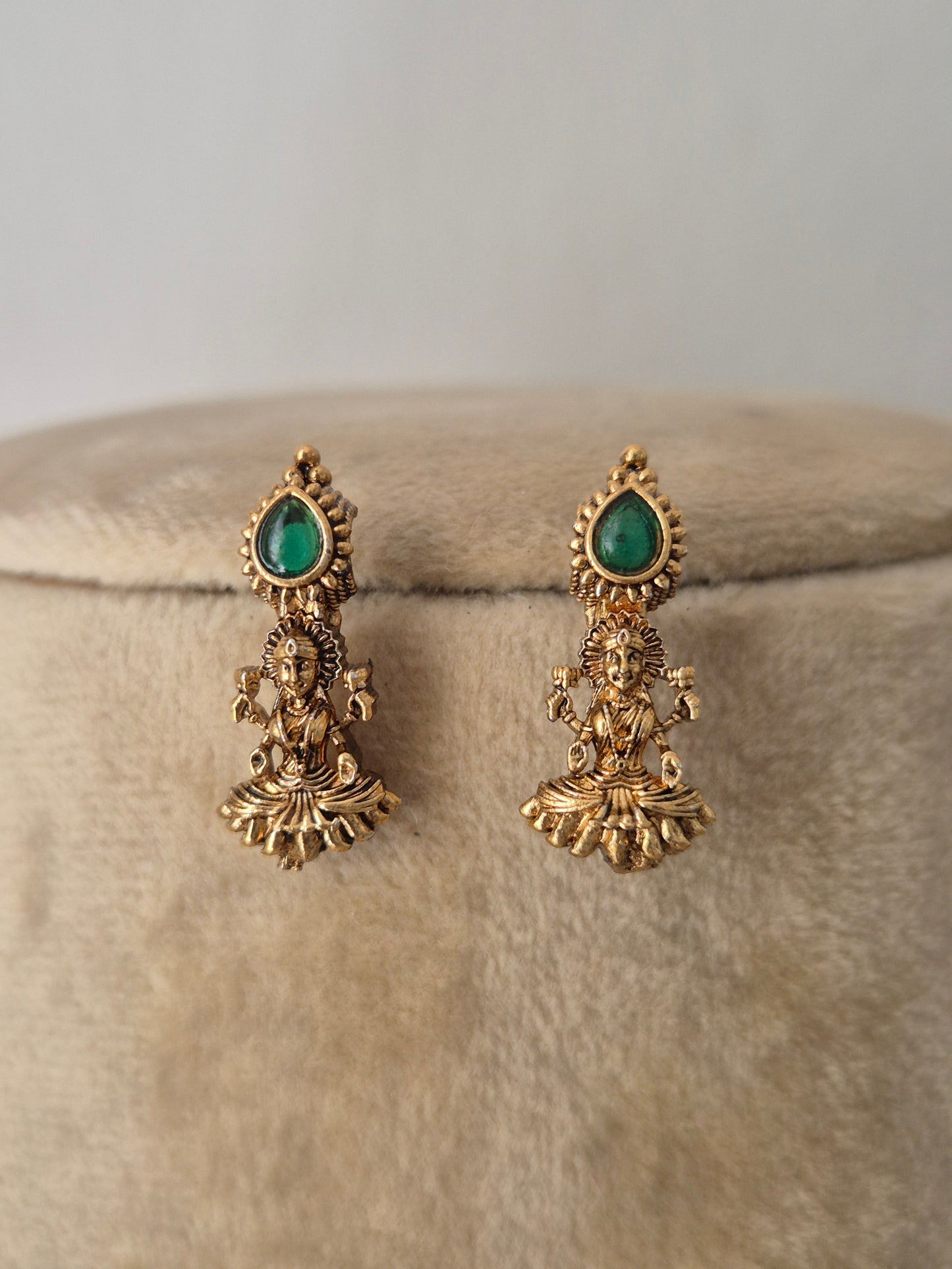 Antique gold-plated earring featuring delicate dangling pendants with tiny emerald green  stone accents, by naitri.in