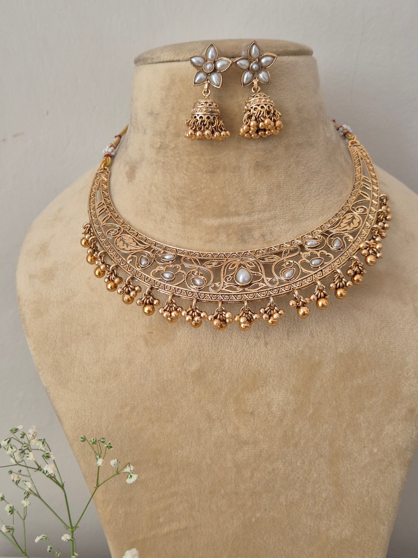 Elegant traditional gold-toned choker jewelry set with detailed metalwork, by naitri.in