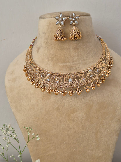 Elegant traditional gold-toned choker jewelry set with detailed metalwork, by naitri.in