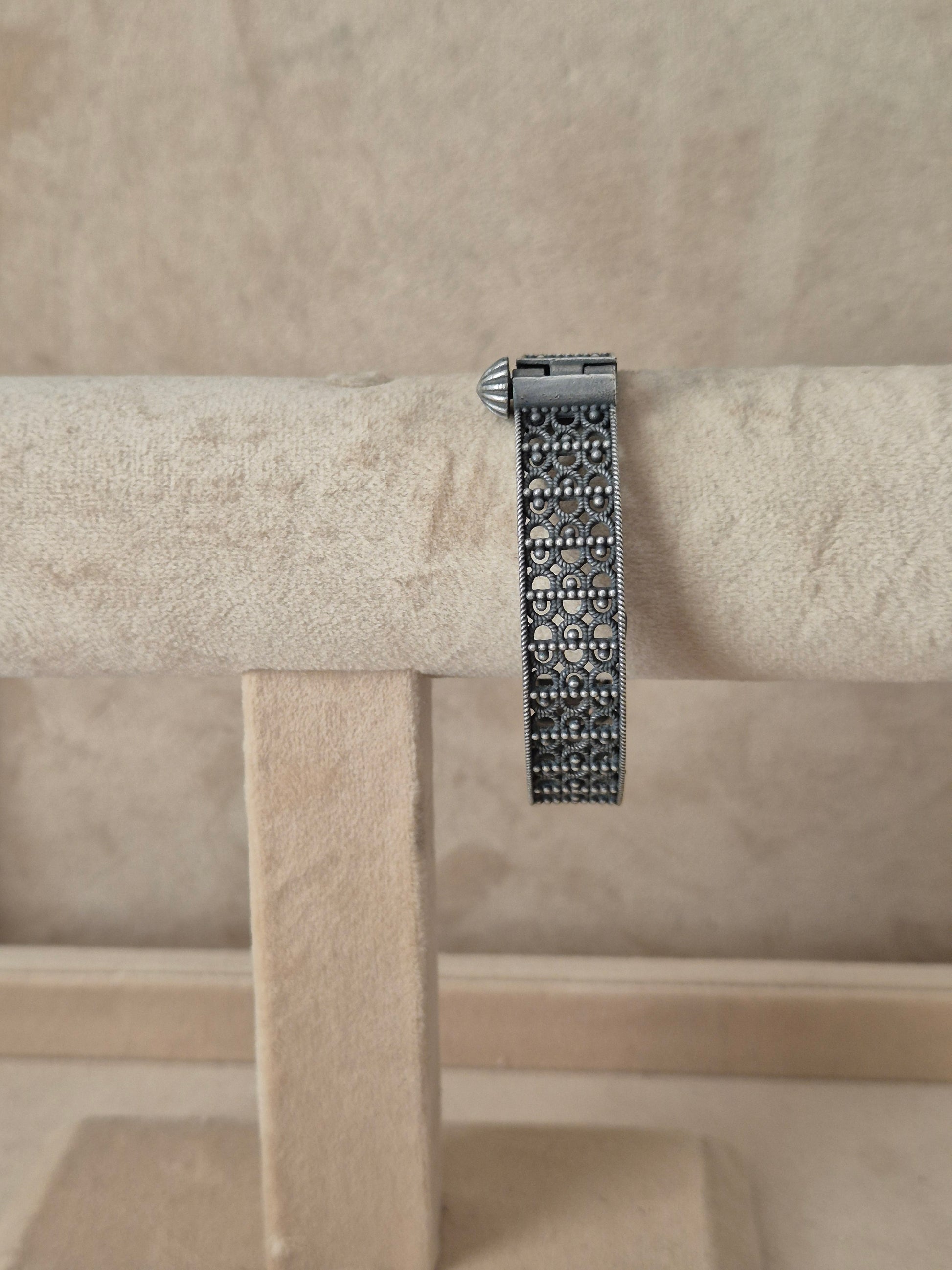 Antique silver oxidized Moana bangle featuring an intricate, deeply engraved floral and vine pattern, by naitri.in