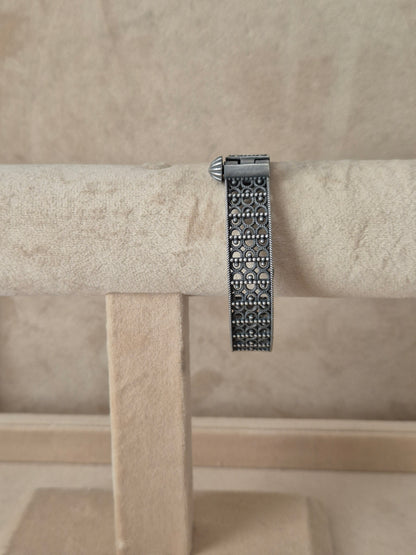 Antique silver oxidized Moana bangle featuring an intricate, deeply engraved floral and vine pattern, by naitri.in