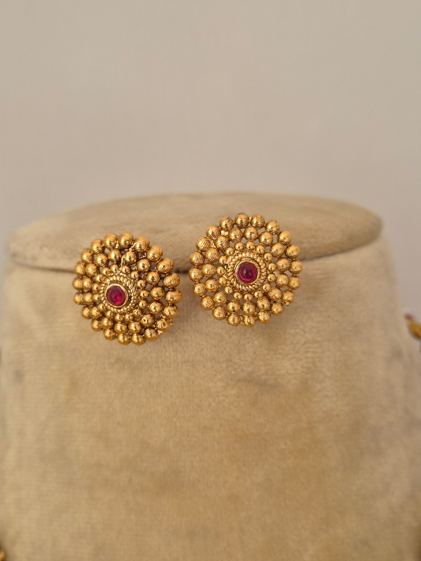 Artisanal Monalisa earring set in a modern Indian aesthetic , stud earrings with red stone centers by naitri.in