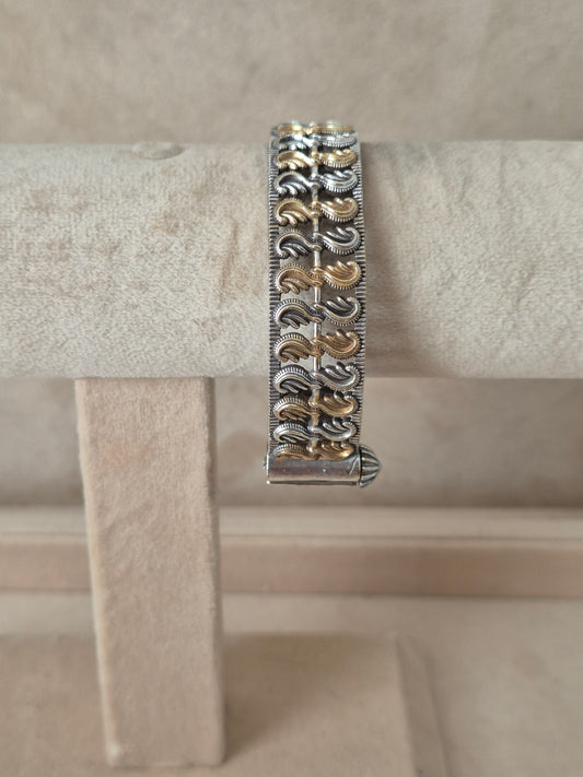 Intricate silver oxidized Monika bangle with a patterned leaf-like design, by naitri.in