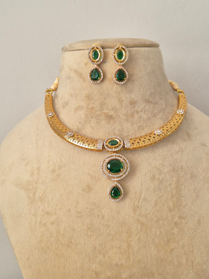 Traditional Indian style golden brass alloy emerald-green choker necklace and earring set from the NAITRI Moumita collection by naitri.in