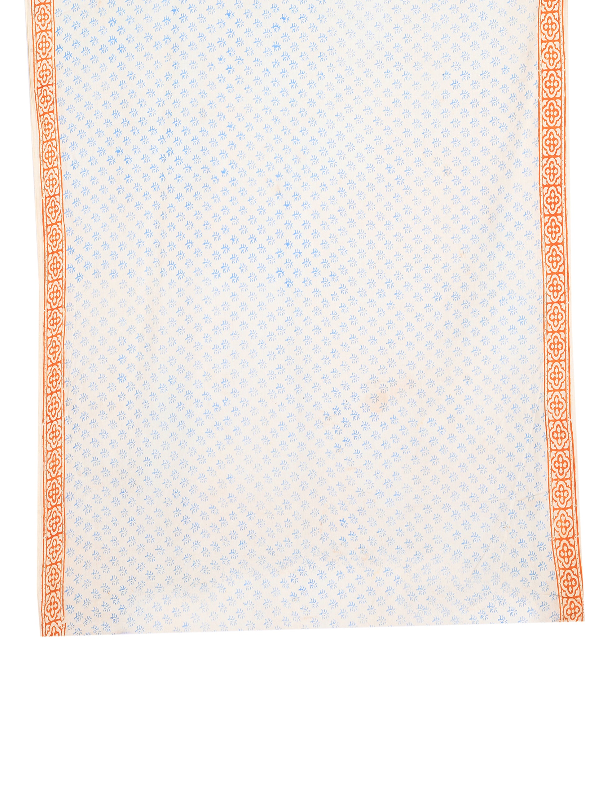 White cotton saree fabric with a mix of soft blue floral patterns and earthy orange paisley borders blouse by naitri.in