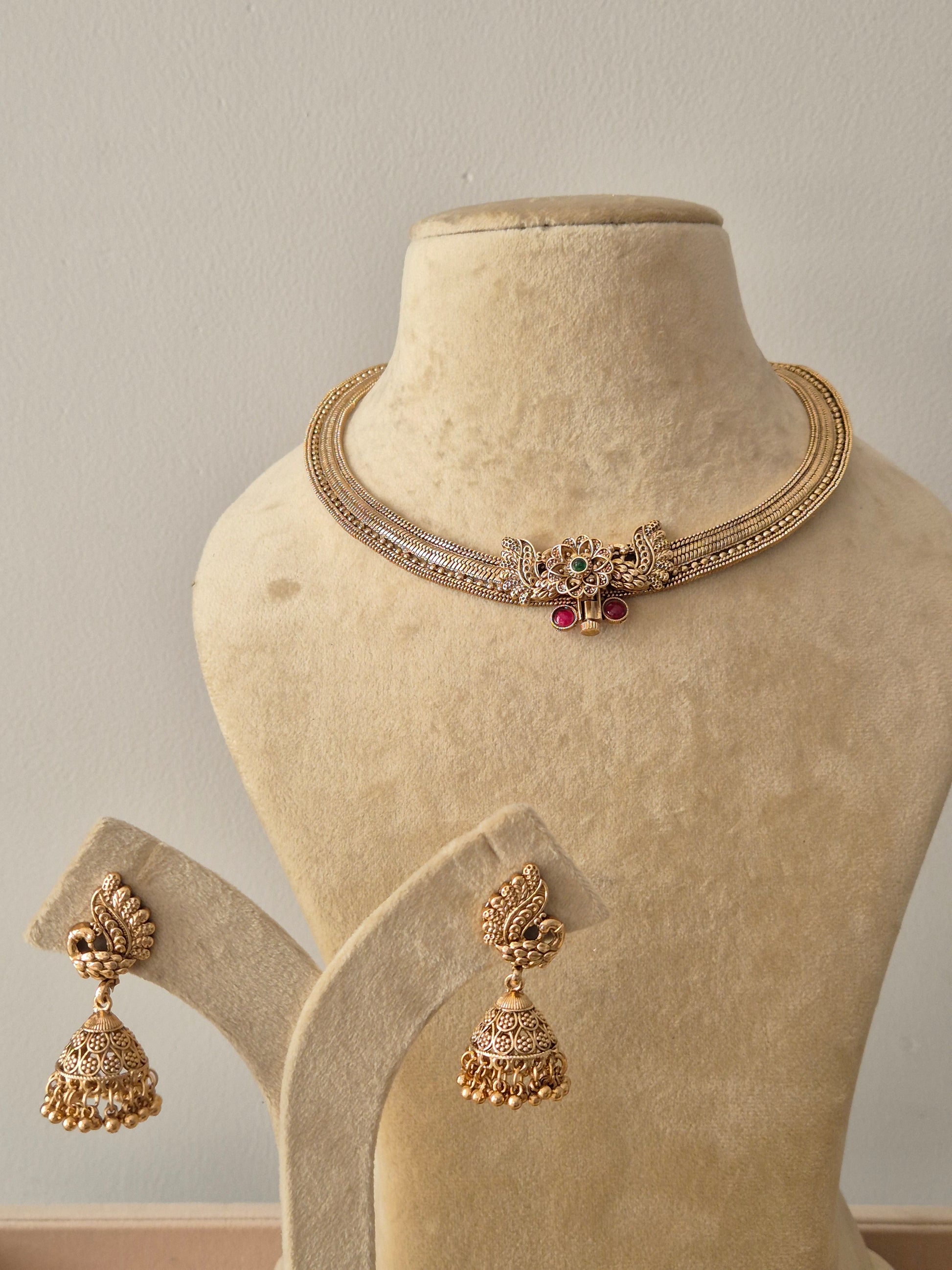  Gold-plated brass choker with peacock motif, green and pink stones, and matching Jhumka earrings by naitri.in
