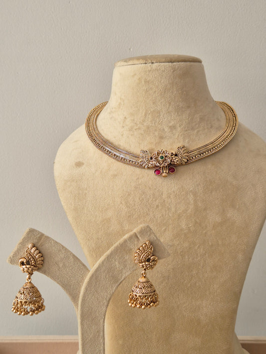  Gold-plated brass choker with peacock motif, green and pink stones, and matching Jhumka earrings by naitri.in