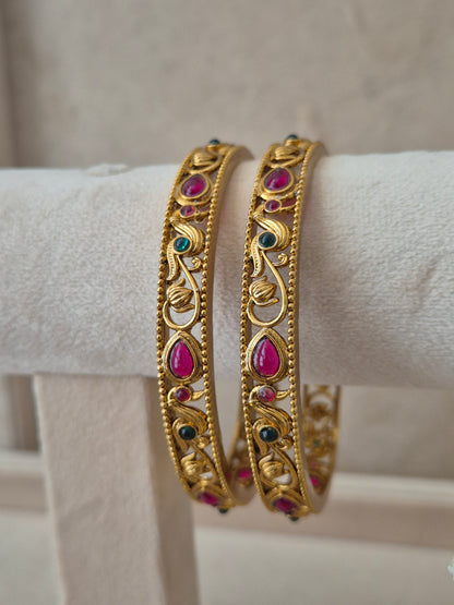 Aadra Bangles set of 2, traditional Indian gold-plated bangles with red and green stones, ethnic bridal and festive jewelry by Naitri.in