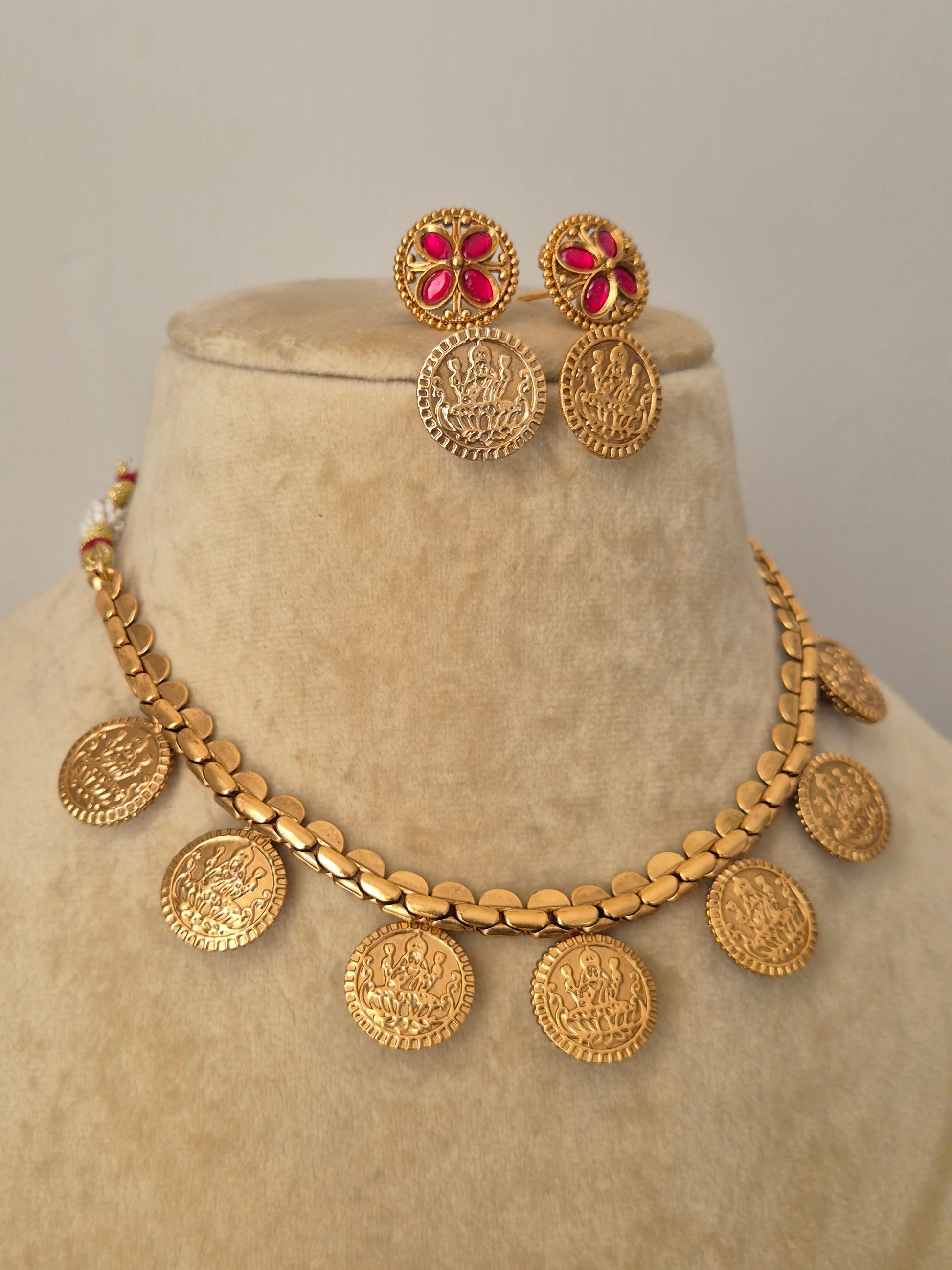 Motifs of goddess crafted on coin clusters on a gold-plated brass chain, featuring matching stud earrings by naitri.in