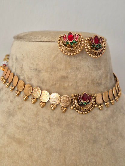 Modern Indian ethnic imitation jewelry set including a golden brass alloy choker with traditional coin details and a vibrant enamel lotus centerpiece by naitri.in