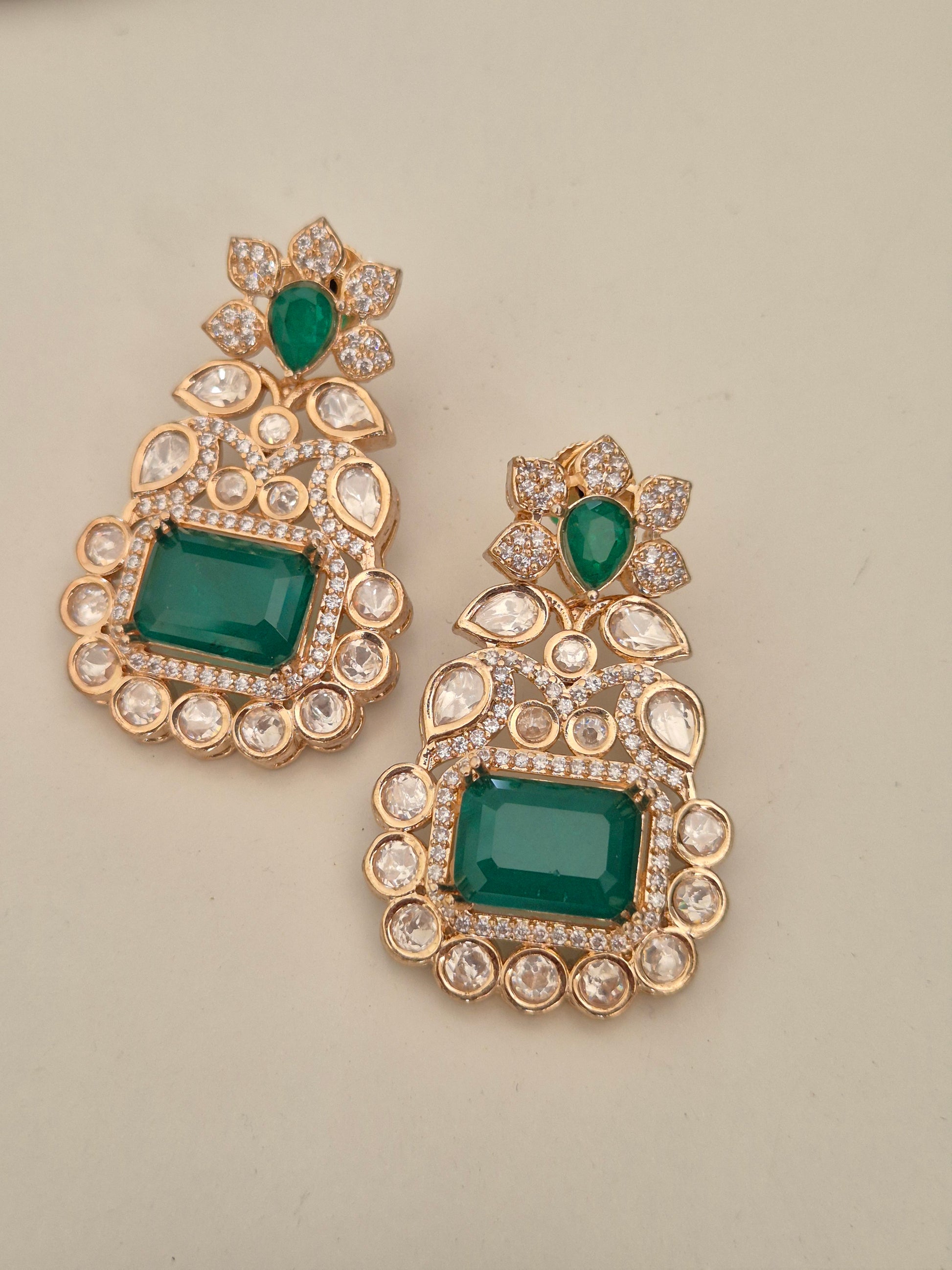 Rose-Gold toned with a large emerald green stone surrounded by clear crystal rectangular drop earring by naitri.in