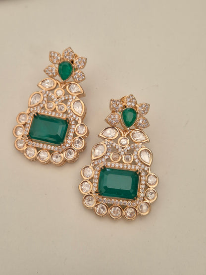 Rose-Gold toned with a large emerald green stone surrounded by clear crystal rectangular drop earring by naitri.in