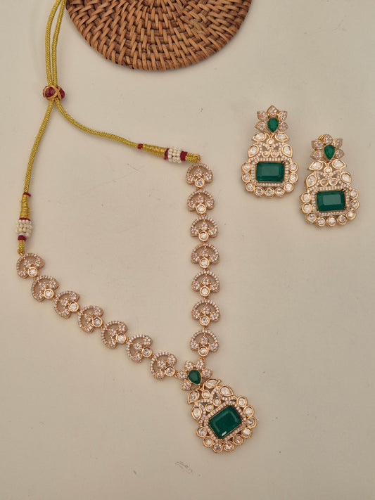 Traditional Indian necklace set with green gemstones and clear American diamonds for festive wear by naitri.in