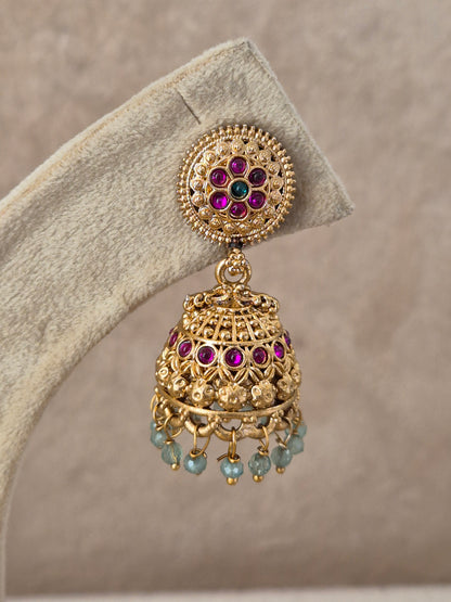 Pair of intricate brass alloy dangle earrings featuring floral studs, bell-shaped jhumkas with colorful red and green stone highlights, and delicate bead drops by naitri.in