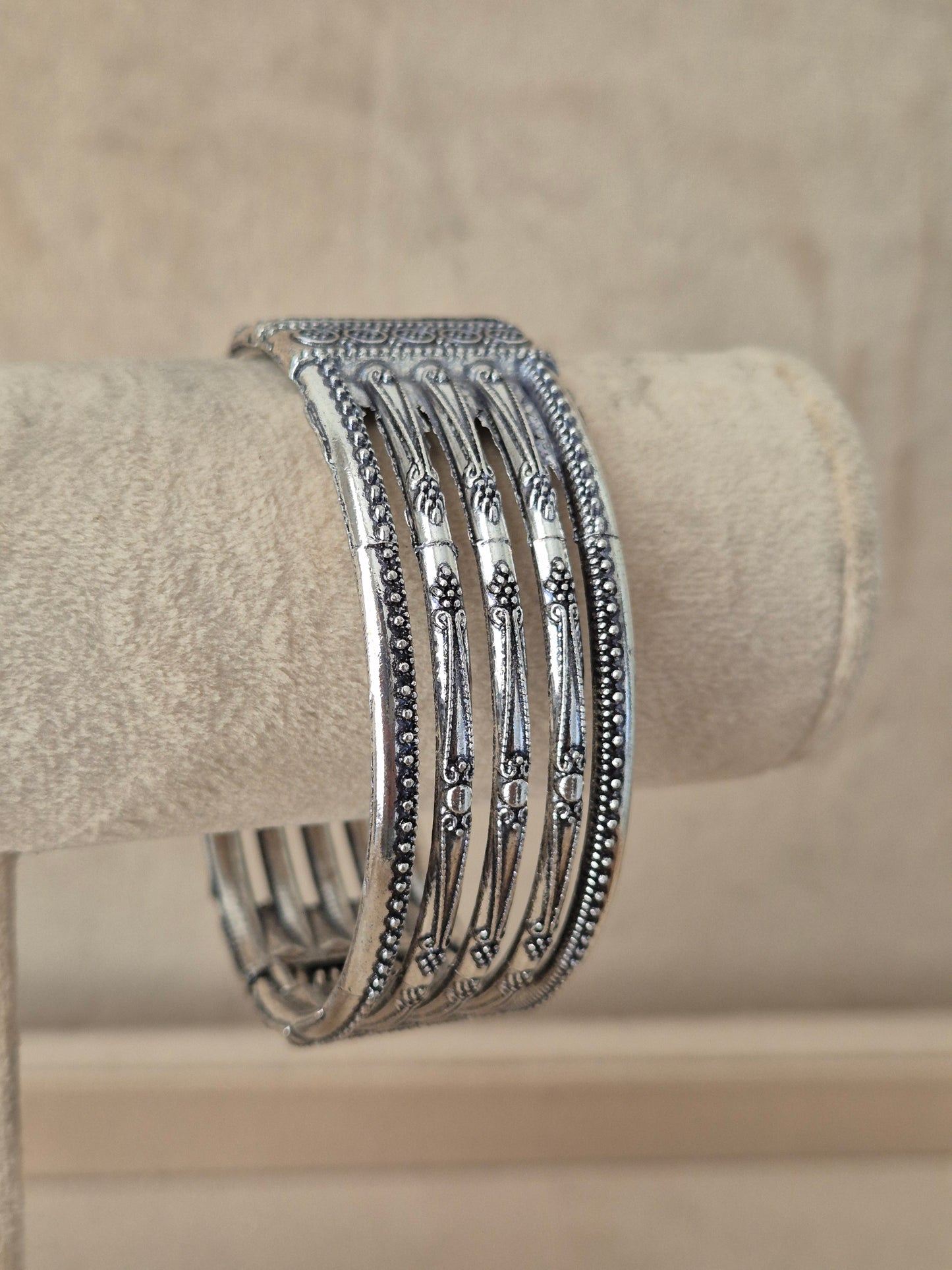 Close-up of Naitri Basanti premium oxidized silver cuff bangle showcasing traditional Indian tribal jewelry craftsmanship with a vintage antique finish by naitri.in