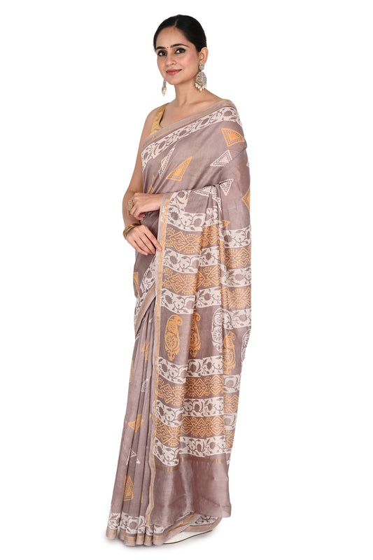 Hand Block Printed Cotton-Silk Saree by Naitri. Authentic Bagh print saree in a grey-mauve tone with gold zari border and traditional Indian artisanal patterns by naitri.in