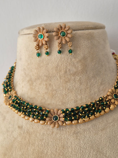 Modern Indian ethnic imitation jewelry set including a multi-layered golden and green beaded strand choker necklace by naitri.in